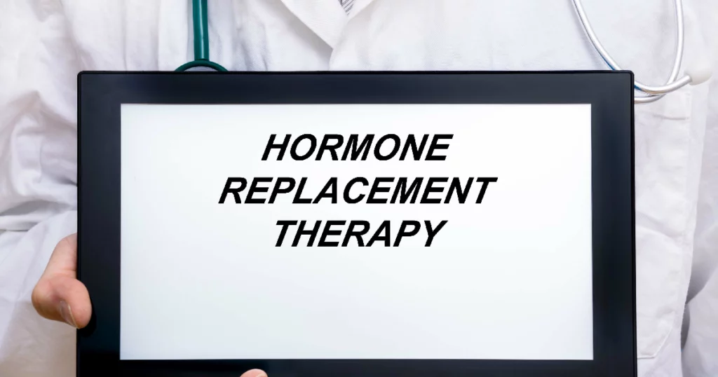 Doctor holding a tablet displaying the words representing Hormone Replacement Therapy (HRT) in Draper, UT.
